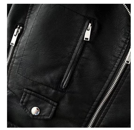 Detail of a Trendy slim-fit jacket Slim-fit Motorcycle Jacket All featuring zipper pockets and textured black imitation leather.
